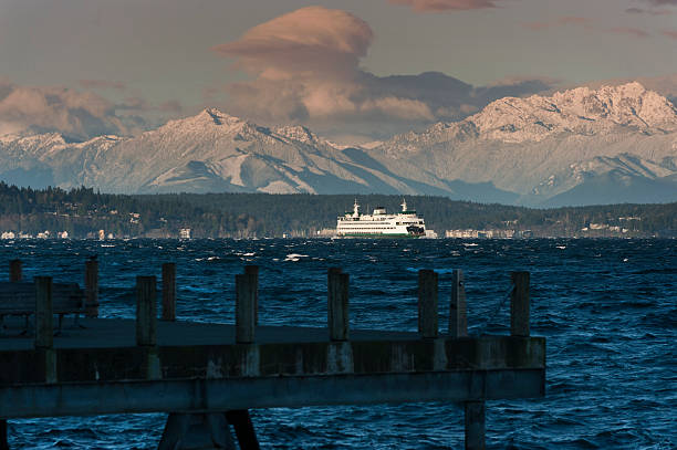 Ferry and Olympic Mountains A fresh dusting of snow on the Olympic Mountains provides a backdrop to a Washington State Ferryboat. bainbridge island photos stock pictures, royalty-free photos & images
