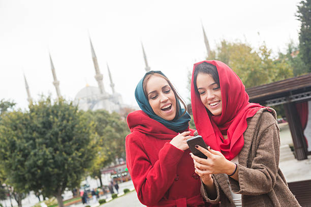 istock Arab Women Wearing Veil Using a Smart Phone in Istanbul 531412873