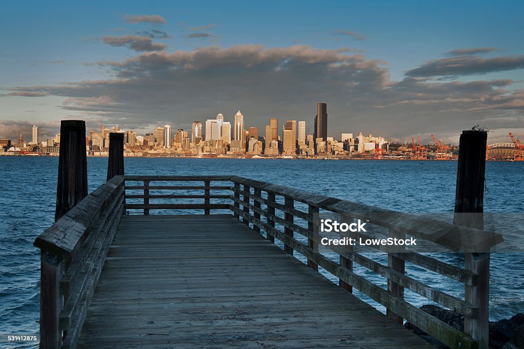 Seattle Skyline Old pilings frame a beautiful view of Seattle, Washington during a gorgeous winter sunset along Elliott Bay. Seattle Stock Photo