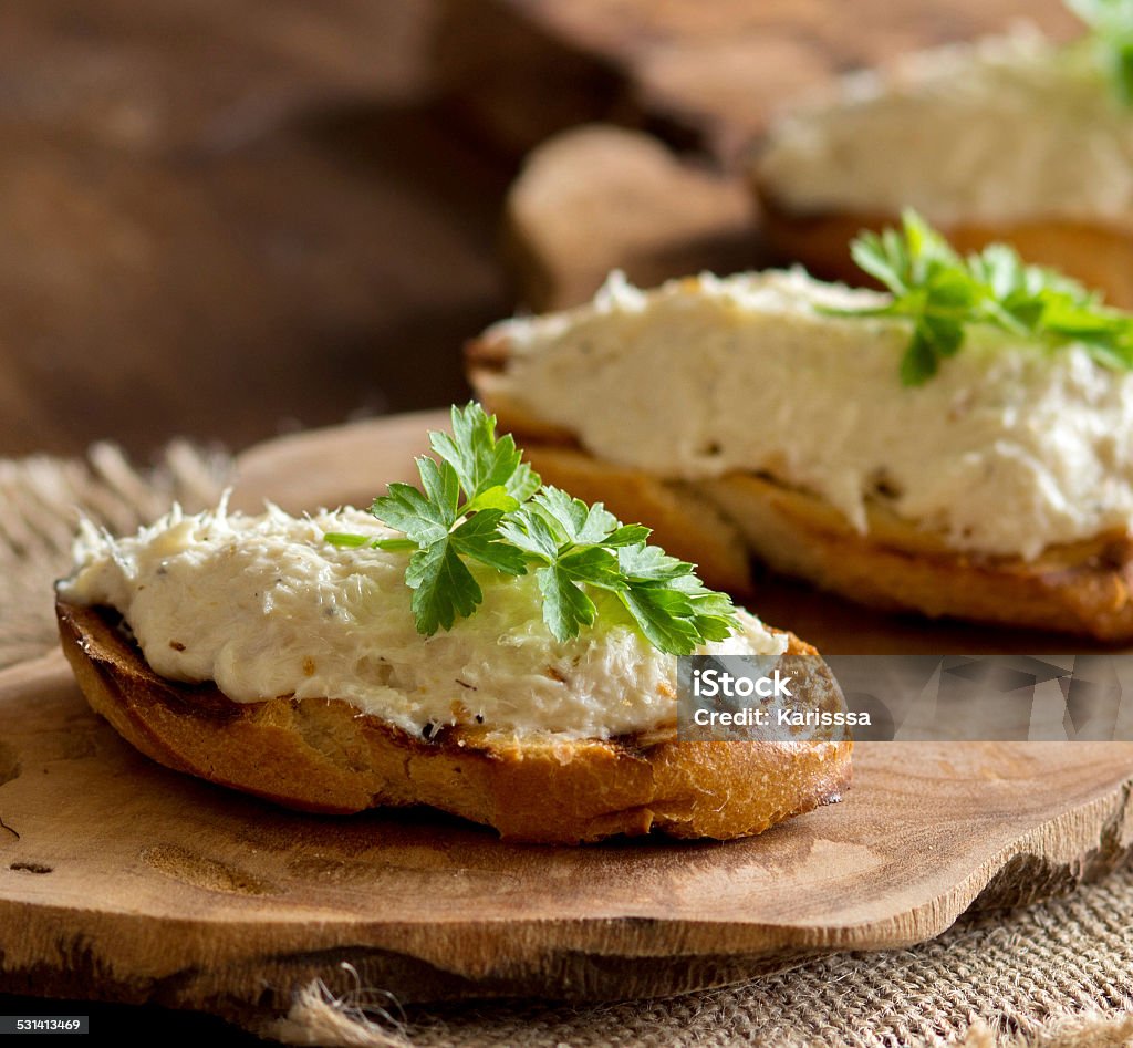 Toasted bread with a salted codfish mousse Toasted bread with a salted codfish mousse on wooden cutting board Cod Stock Photo