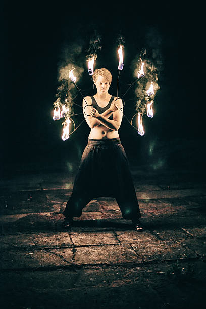istock active girls carries out tricks for fire show at night 531414497