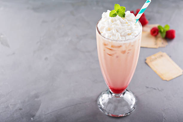istock Iced milkshake with raspberry syrup and whipped cream 531415112
