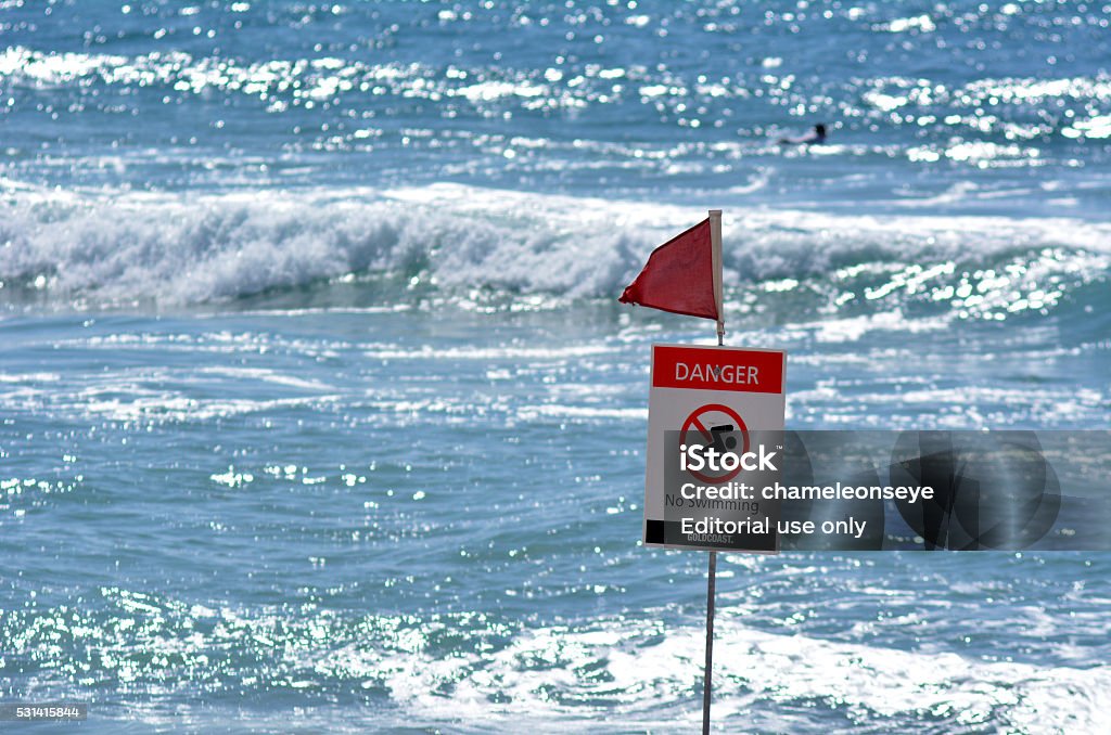 Australian Lifeguards in Gold Coast Queensland Australia Gold Coast, Australia - September 28, 2014: Australian person swims in the sea in a red flag area. According to Australia National Drowning report 300 people drown in 2012 with cost of $1 billion to the Australian economy. Accidents and Disasters Stock Photo