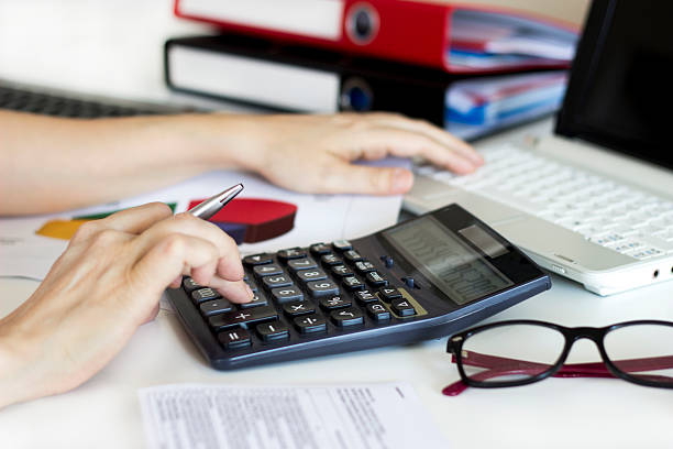 istock Businesswoman analyzing graphic and using calculator in the office 531416662