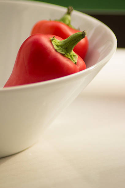 Fresh raw peppers in dish