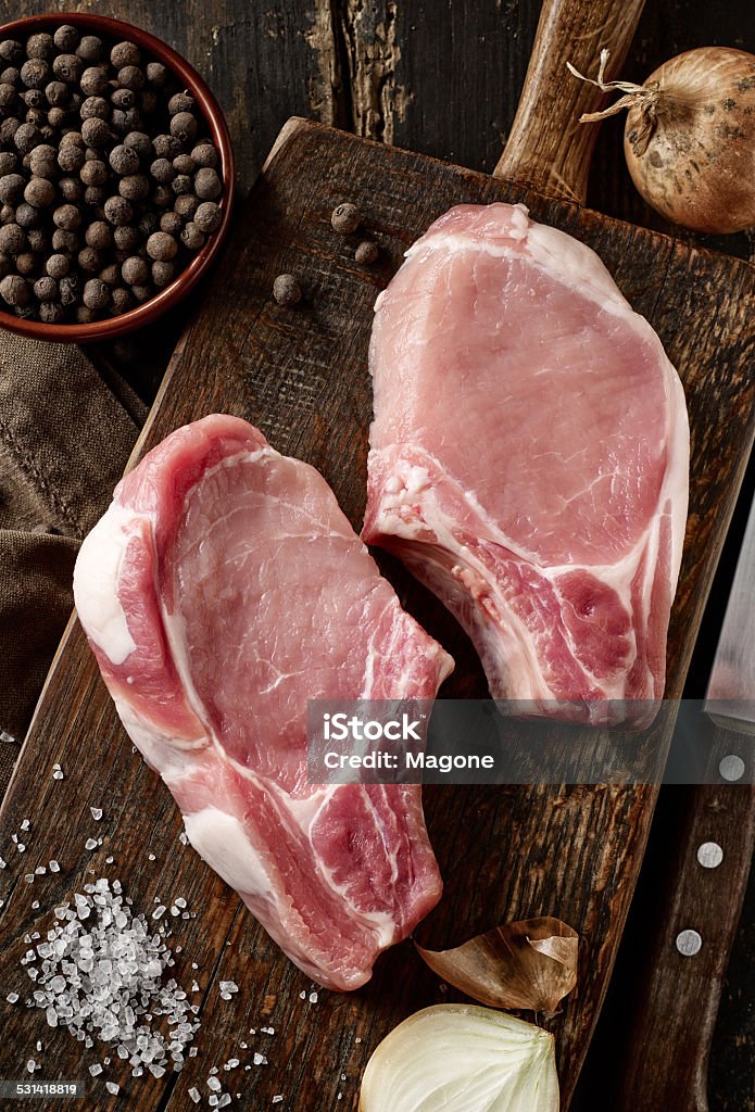 fresh raw meat on wooden cutting board fresh raw meat on dark wooden cutting board 2015 Stock Photo