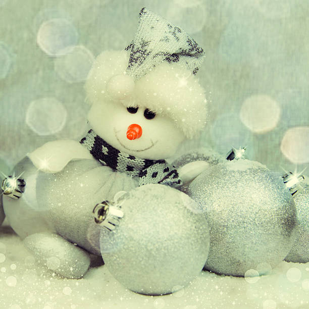 istock Snowman and Christmas decorations on a silver background. 531418844