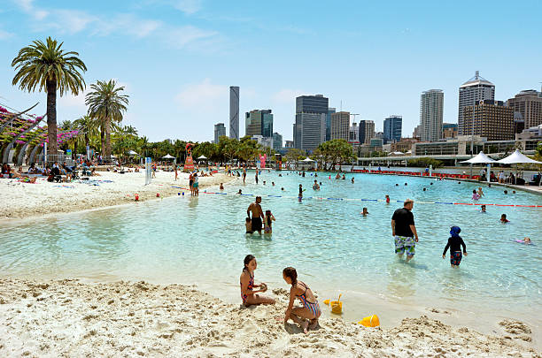 City beach with two surfers walking along