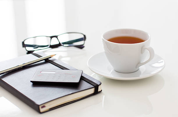 White cup of tea on table stock photo