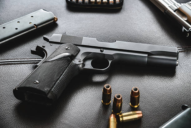 istock .45 Caliber hollow point bullets near handgun and magazine 531420114