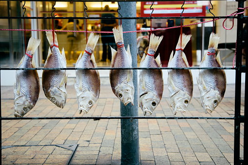 Hanging dried fish for sale in a high street shop,  Hong Kong. 