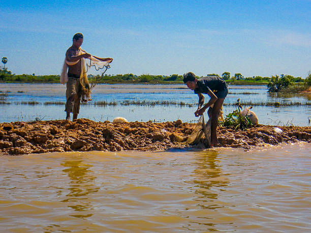 due persone con reti da pesca in sap tole lago, cambogia - flood people asia cambodia foto e immagini stock