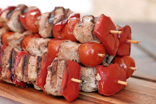 Stacked And Skewered Barbecued Shish Kebabs On The Wood Cutting Board, Close Up, Top View