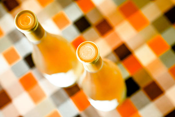 Two bottle tops of sweet white wine, gold tone, selective focus,