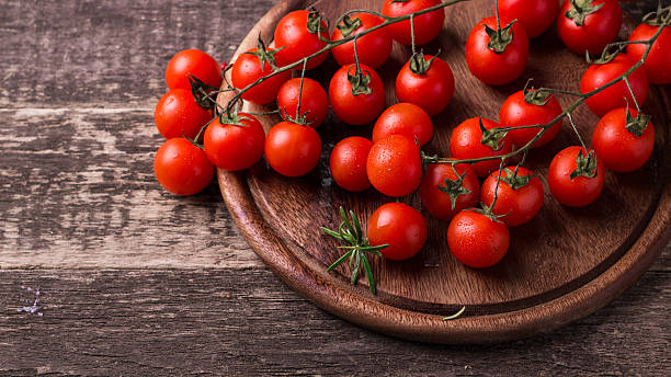 istock cherry tomatoes on wooden background 531421796