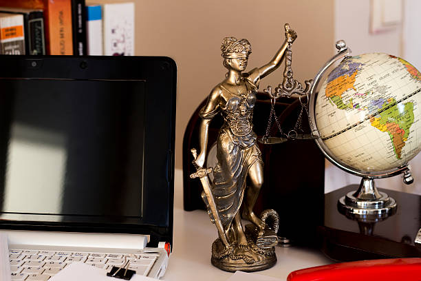 istock Law and business concept, statue, world map and laptop 531421996