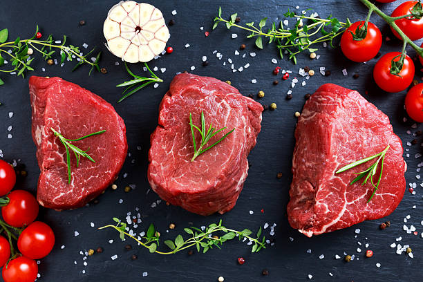 istock Fresh Raw Beef steak Mignon, with salt, peppercorns, thyme, garlic. 531422386
