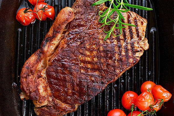 istock Grilled Beef Sirloin Steak on iron pan with vegetables. 531423732