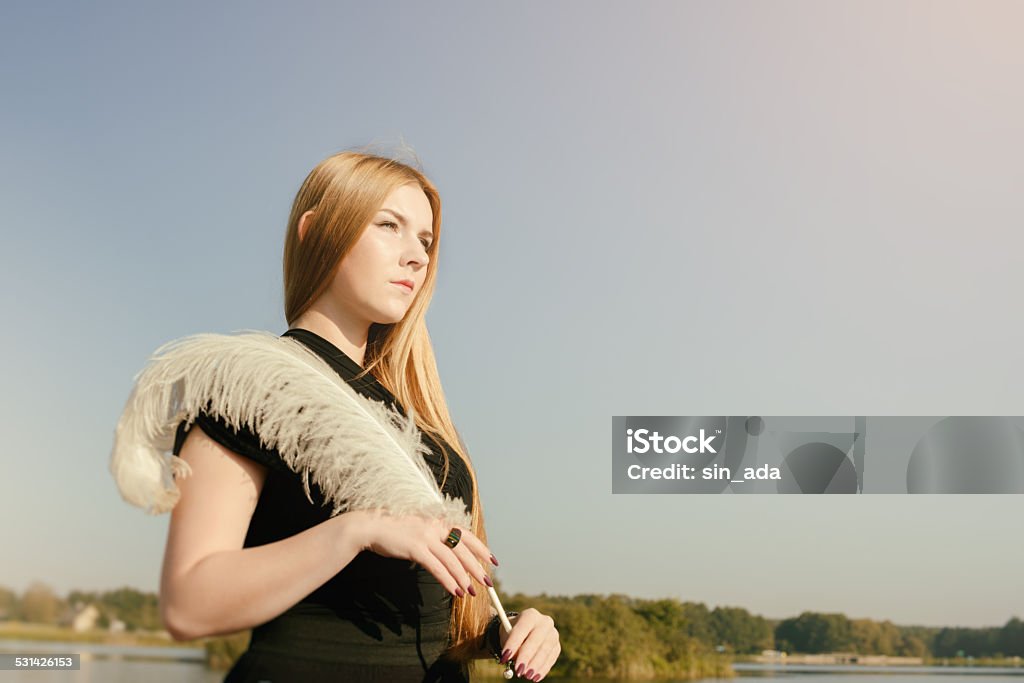 unusual gothic girl with long red hair and feather unusual gothic girl with long red hair and white feather 2015 Stock Photo