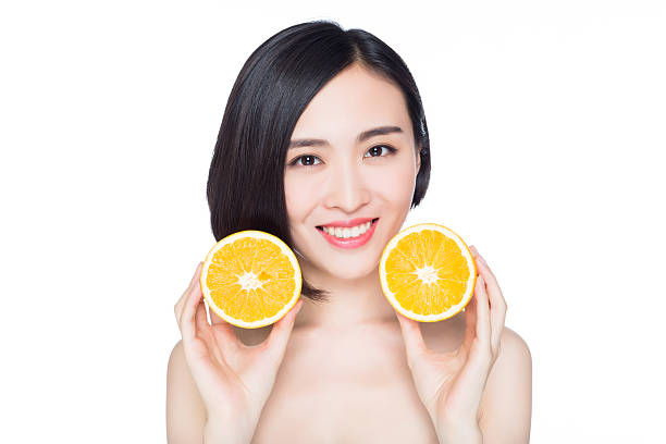 istock chinese woman with oranges in her hands 531428297