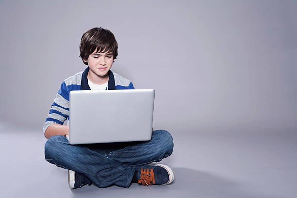 istock Cute teenage boy using laptop 531430039