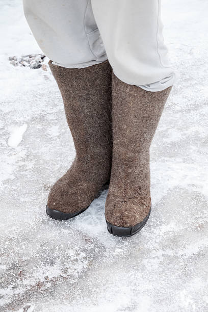 istock Feet with traditional Russian gray felt boots stand 531440003
