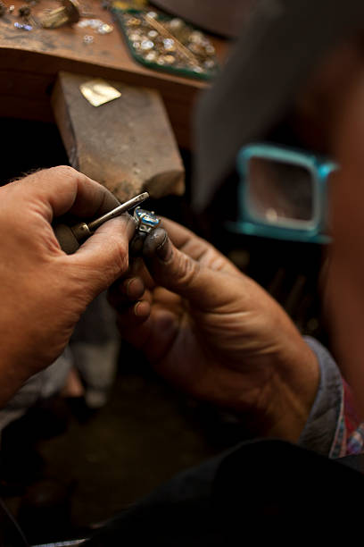 istock Jeweller Filing a Topaz Ring 531440405