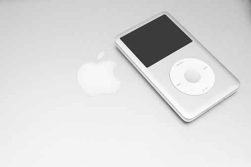 Pavlograd, Ukraine - December 18, 2014: iPod classic 160 Gb on silver macbook. Studio shot.