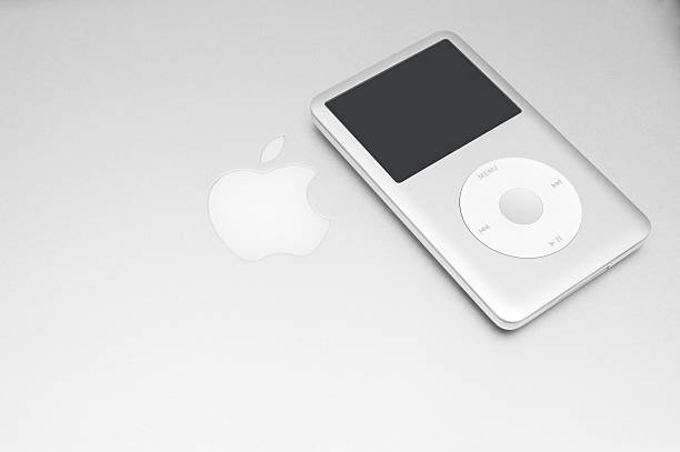 iPod classic 160 Gb on silver macbook Pavlograd, Ukraine - December 18, 2014: iPod classic 160 Gb on silver macbook. Studio shot. mp3 player stock pictures, royalty-free photos & images
