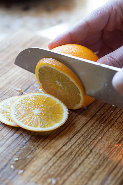 Slicing the orange stock photo