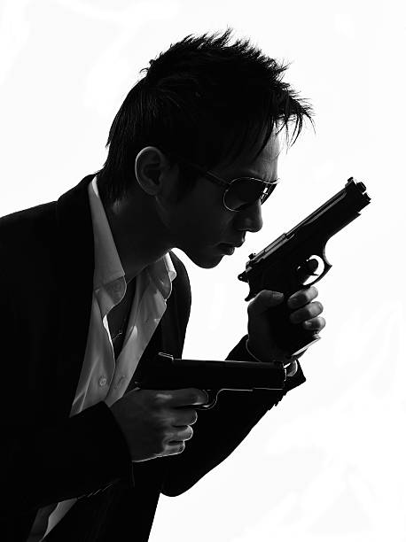 istock asian gunman killer  portrait silhouette 531445109