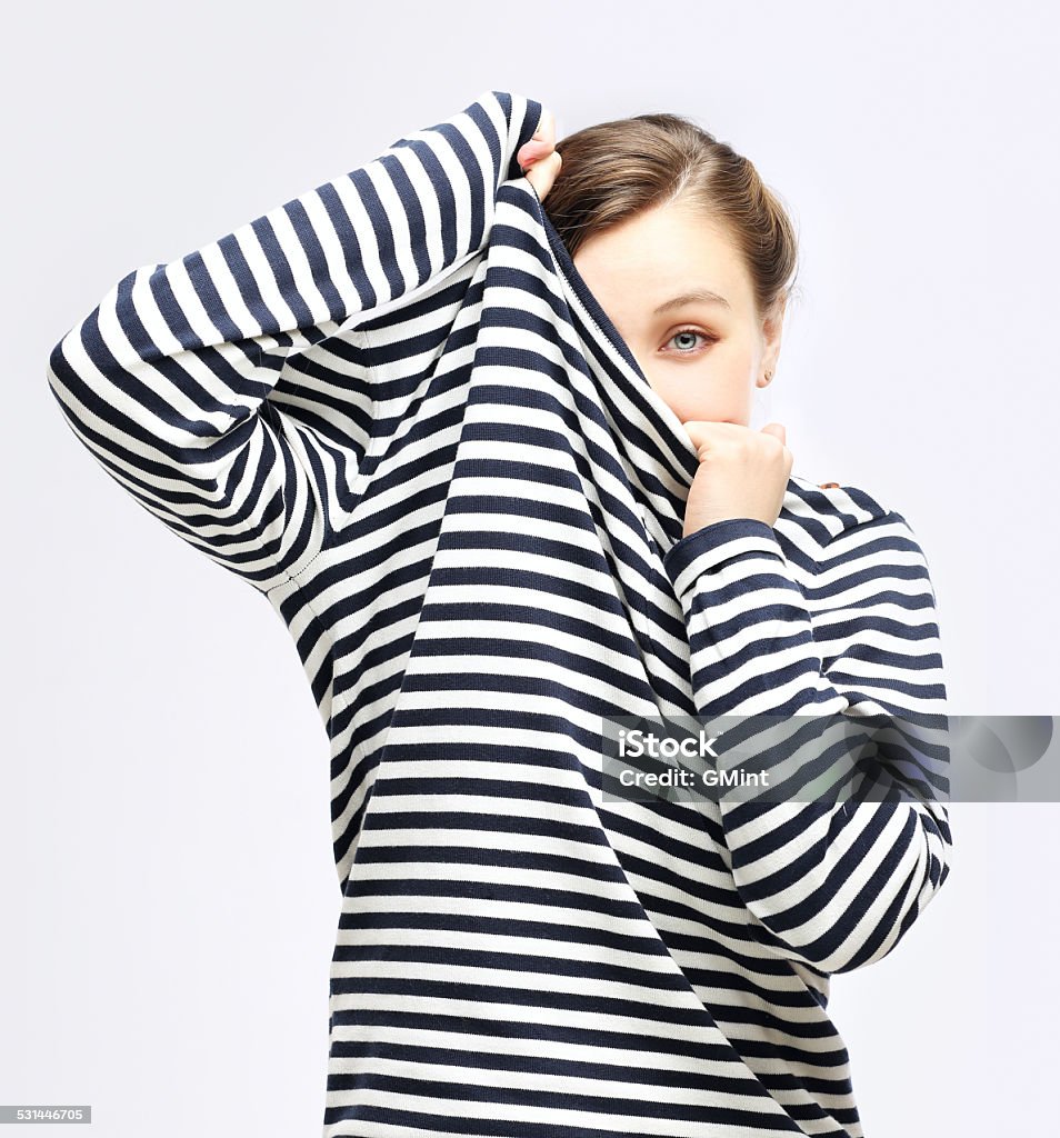 Girl  tucking herself in  striped  sweater 2015 Stock Photo