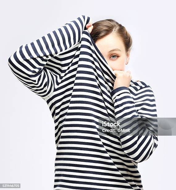 Girl Tucking Herself In Striped Sweater Stock Photo - Download Image Now - 2015, Adolescence, Adult
