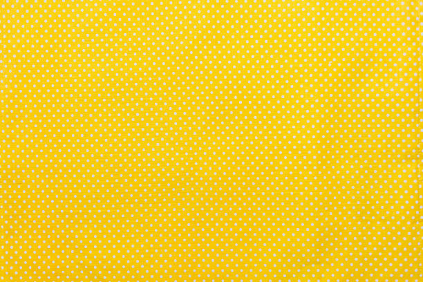 Yellow and white polka dots tablecloth picnic texture. Yellow and white polka dot tablecloth picnic texture. Textile, napkin, tablecloth. View from above, top. Traditional pattern and color. mustard yellow fabric stock pictures, royalty-free photos & images