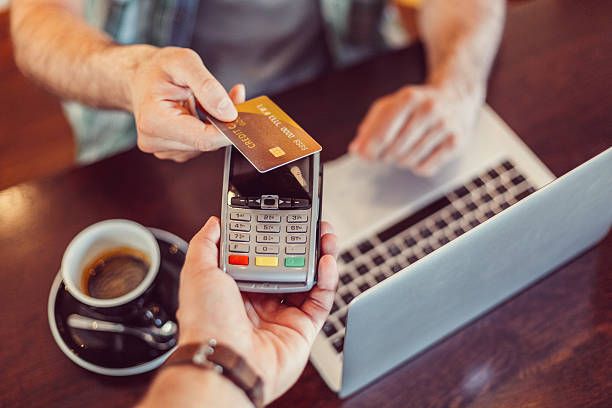 istock Man in a cafe making contactless credit card payment 531455718