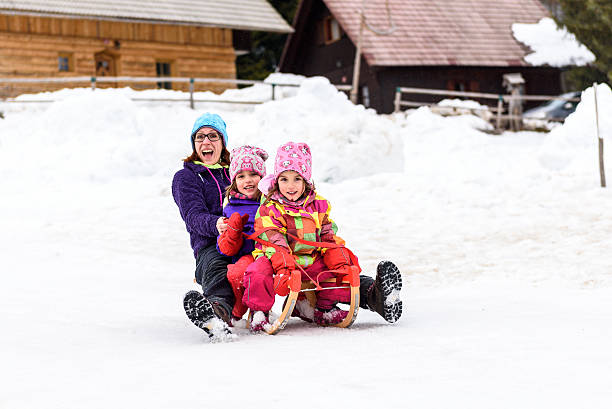 istock Family is sledding down the snowy slope 531456306