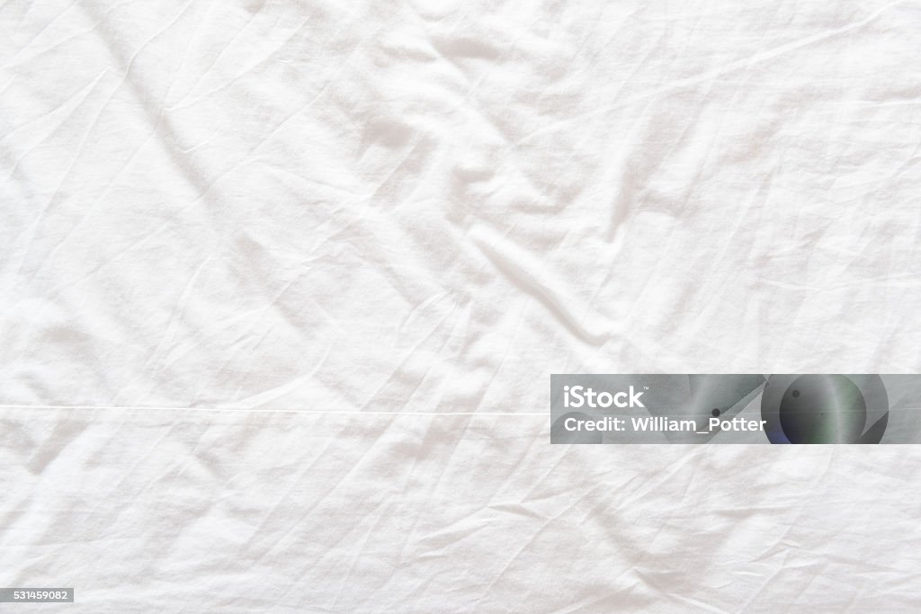 Top view of a messy bedding sheet after night sleep. Top view of a messy bedding sheet after a long night sleep and waking up in the morning. Sheet - Bedding Stock Photo
