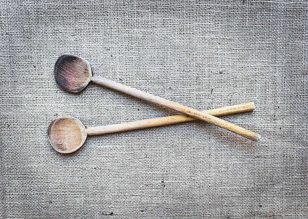 istock Two rustic wood cooking spoons over a sackcloth surface 531459951