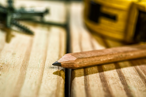 Carpenter's Pencil and Measureing Tape sitting on a newly contructed outdoor deck, built with 2X6 Pressure Treated Southern Yellow Pine, this dimensional lumber typically used for residential decking and other outdoor projects.