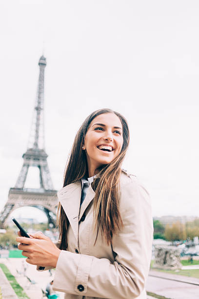 istock Cheerful young woman holding smart phone 531462638