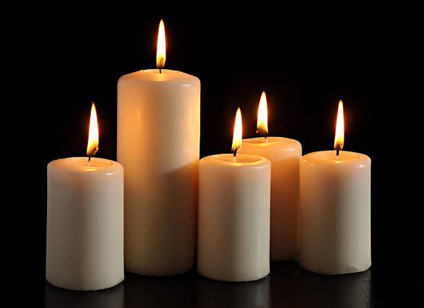 six candles on a black background. stock photo