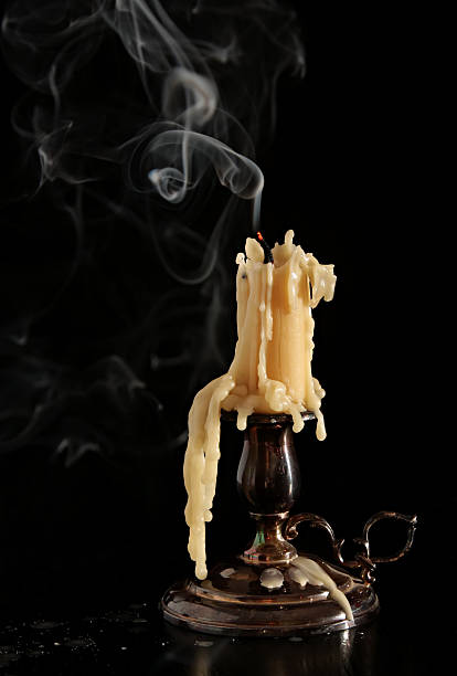 istock burning old candle vintage bronze candlestick. On black background. The 531462653