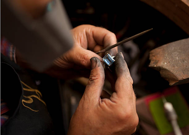 Ring being filed in a workshop Ring being filed in a workshop jewelry craftsperson craft jeweller stock pictures, royalty-free photos & images