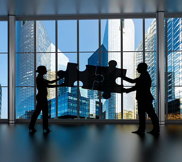 istock business partners connecting two puzzle pieces i 531464962