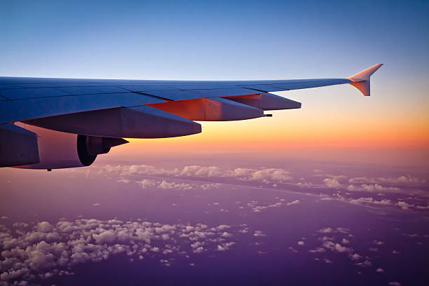 Auckland, New Zealand - May 15, 2016: Looking out the window of an Airbus A380-800 jet airplane at sunset during flight. Photo taken in the evening over the Tasman sea after leaving Auckland International Airport New Zealand