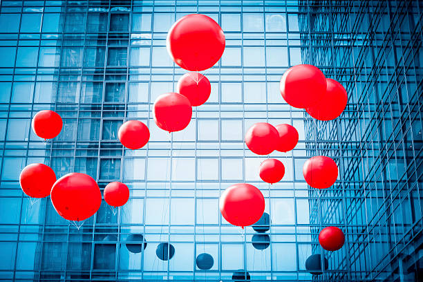 istock red balloon with blue modern glass building 531465689