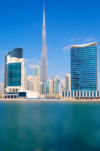 Vertical view of Dubai skyline with blue sky, UAE.