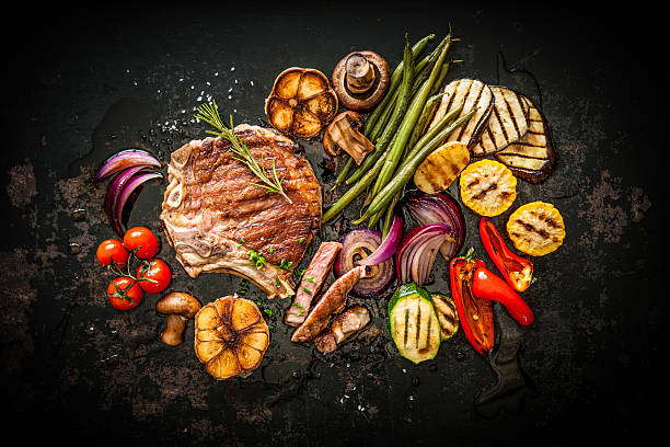 Beef steak with grilled vegetables Beef T-Bone steak with grilled vegetables and seasoning on dark background griddle stock pictures, royalty-free photos & images