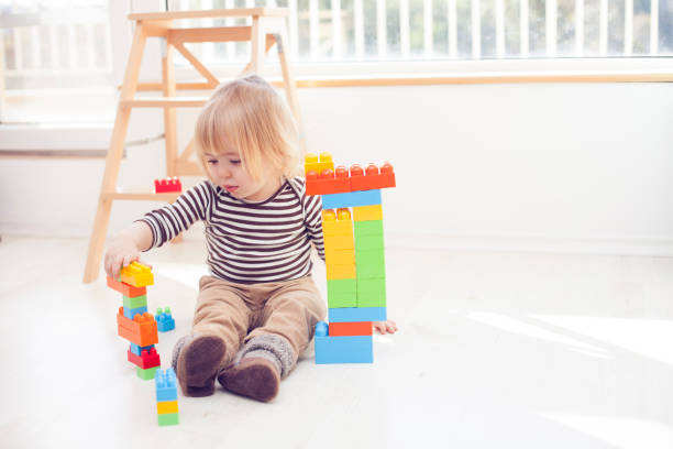 istock Little blond child playing with colorful plastic blocks 531466620