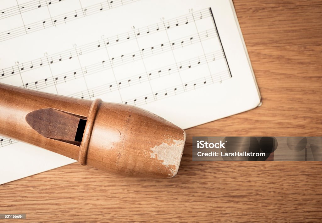 Wooden recorder and notes in close up Close up of wooden recorder and notes on paper. Concept of playing the flute, music  and melody. Recorder - Musical Instrument Stock Photo